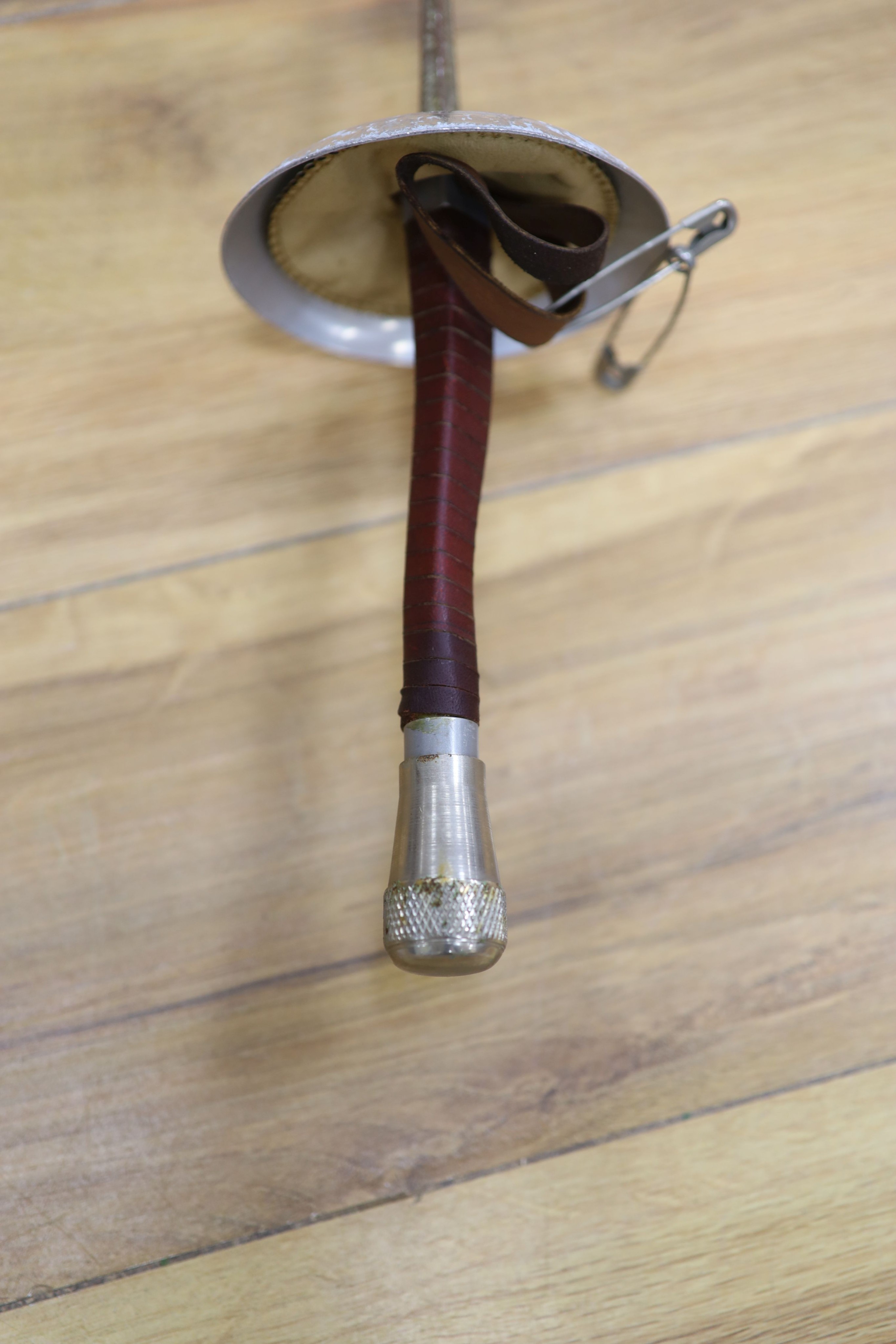 A fencing foil and accessories